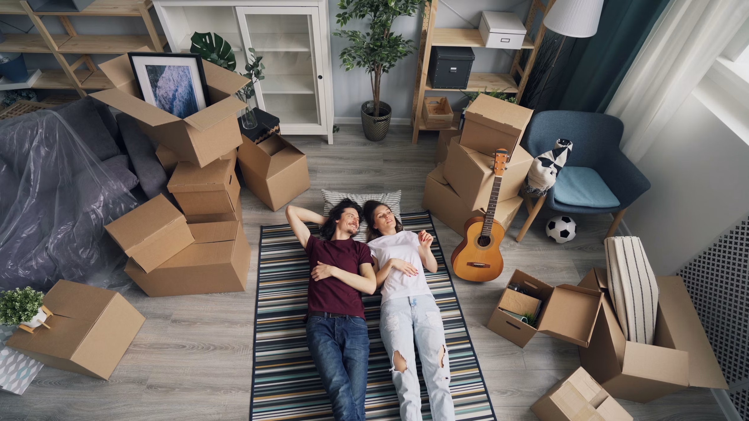 A Forward Thinking Movers customer resting among packed boxes after their move
